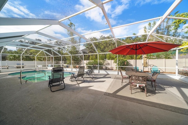 view of swimming pool featuring a patio area and glass enclosure