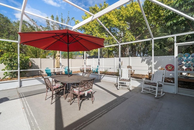 view of patio featuring glass enclosure