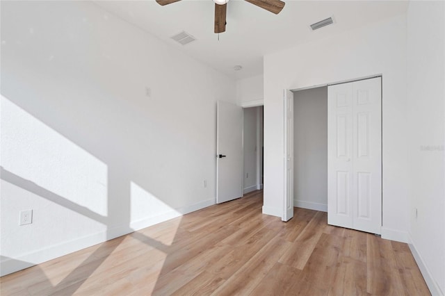 unfurnished bedroom with ceiling fan, light hardwood / wood-style floors, and a closet