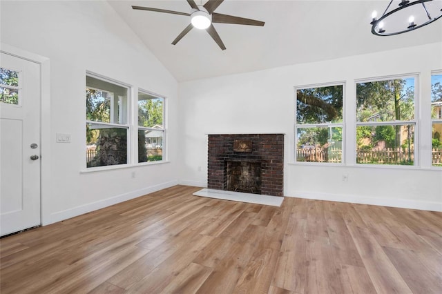 unfurnished living room featuring a fireplace, light hardwood / wood-style floors, and plenty of natural light