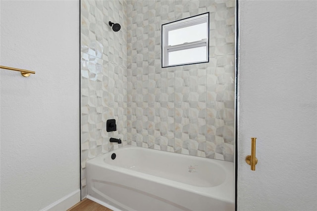 bathroom with hardwood / wood-style floors and  shower combination