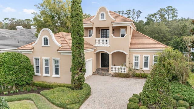 view of front of home featuring a garage and a balcony