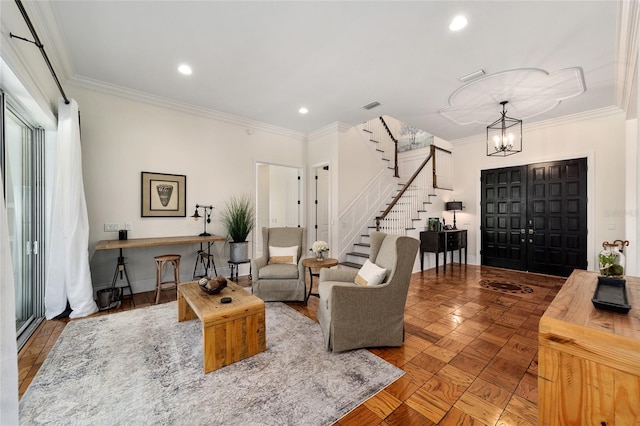 living room featuring parquet floors, a notable chandelier, and ornamental molding