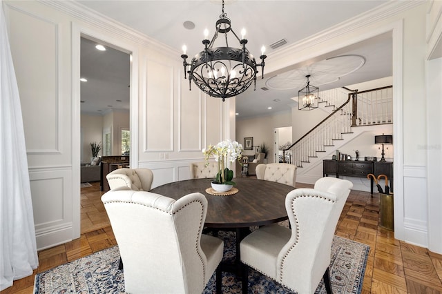 dining space with parquet flooring and ornamental molding