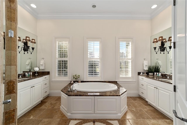 bathroom with vanity, crown molding, and a tub