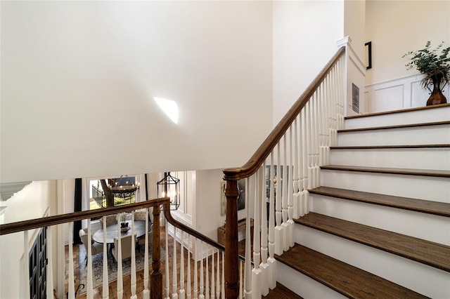 stairs with an inviting chandelier