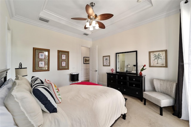 carpeted bedroom with ornamental molding, a raised ceiling, and ceiling fan