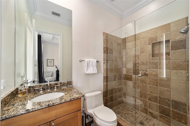 bathroom featuring vanity, ornamental molding, toilet, and walk in shower