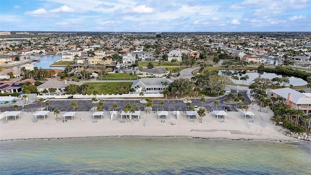 bird's eye view featuring a view of the beach and a water view