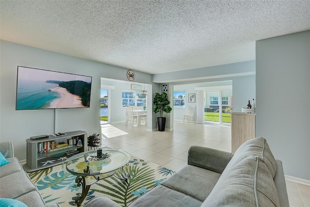 living room with light tile patterned floors and a textured ceiling