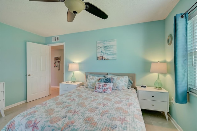 tiled bedroom with ceiling fan