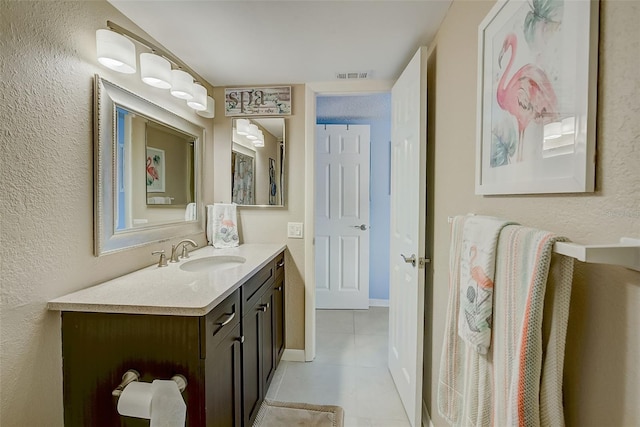 bathroom with tile patterned flooring and vanity