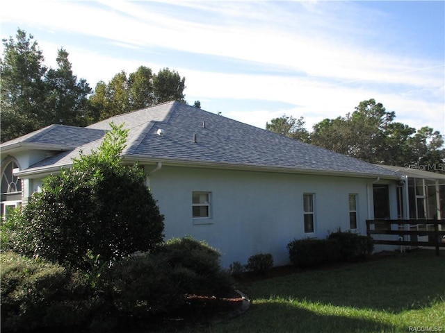 view of property exterior with a yard