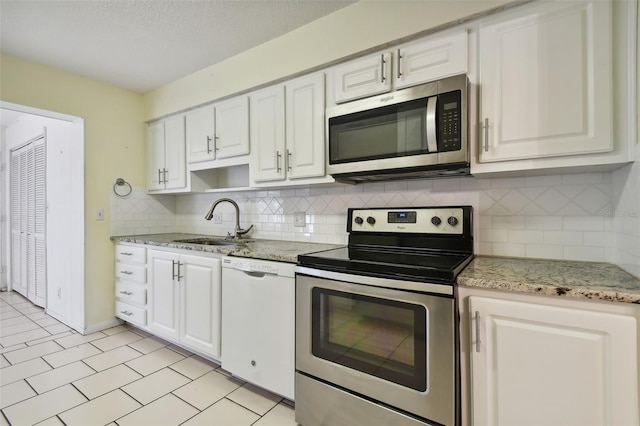 kitchen with white cabinets, stainless steel appliances, and sink