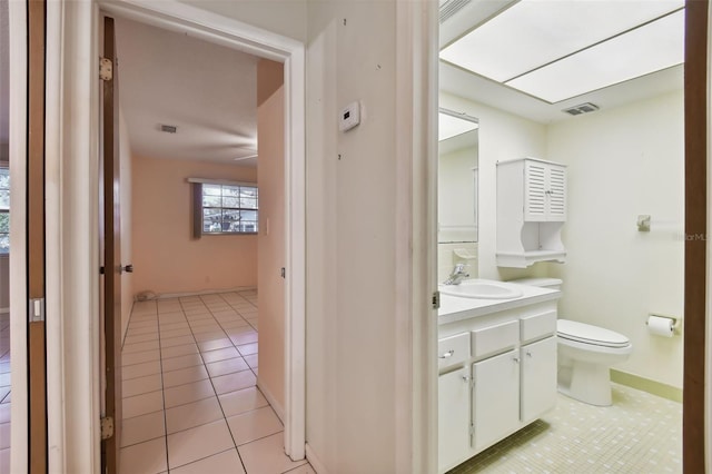 bathroom with vanity, toilet, and tile patterned floors