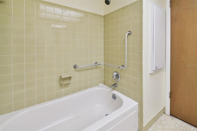 bathroom with tile patterned floors and tiled shower / bath combo