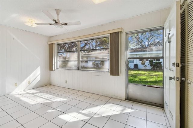 interior space with ceiling fan and light tile patterned flooring