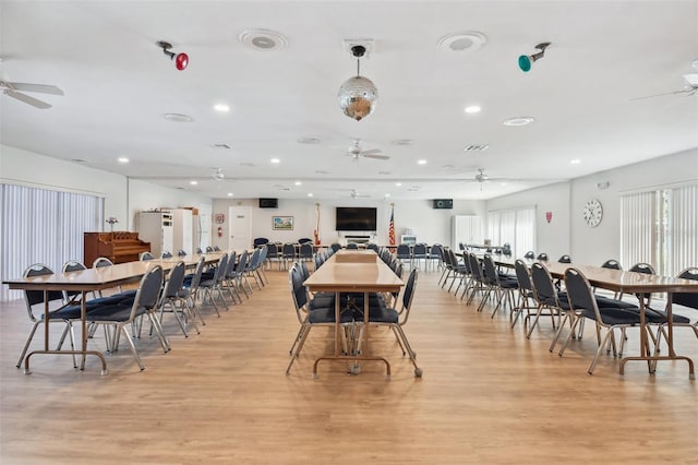 dining space with light wood-type flooring, a healthy amount of sunlight, and ceiling fan