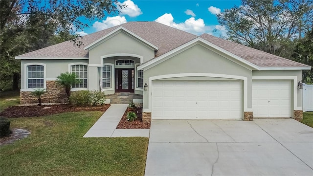 single story home with a front yard and a garage