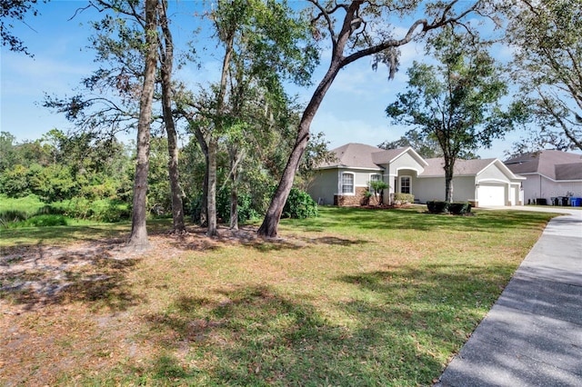 view of front of house featuring a garage and a front lawn