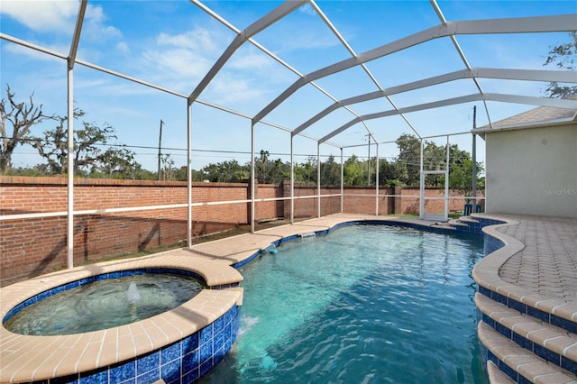 view of pool with an in ground hot tub, pool water feature, a patio, and a lanai