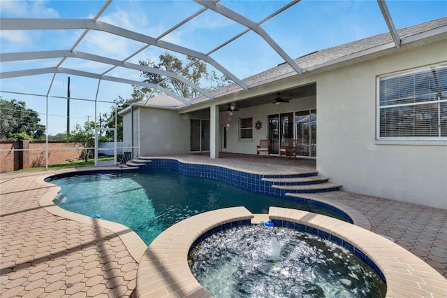 view of swimming pool featuring an in ground hot tub, ceiling fan, a patio area, and a lanai