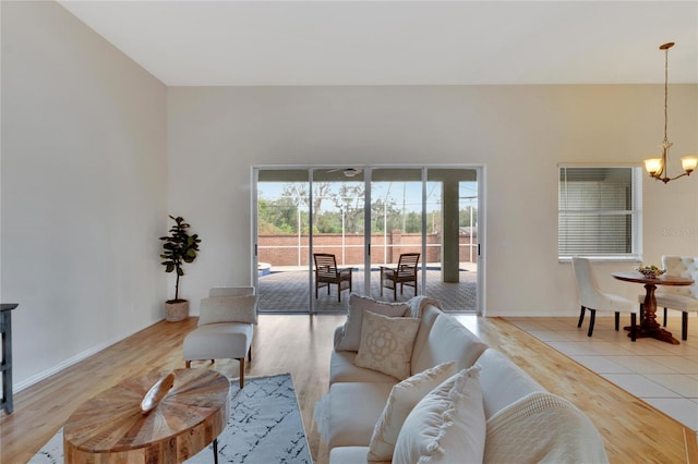 living room featuring a notable chandelier and light hardwood / wood-style floors