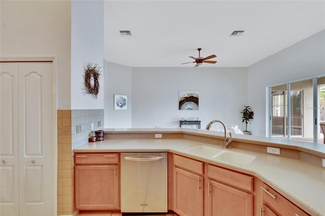 kitchen featuring stainless steel dishwasher, sink, light brown cabinetry, and ceiling fan