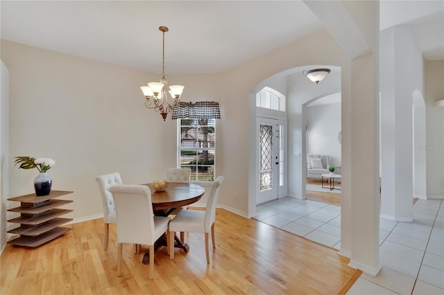 dining space featuring a notable chandelier and light hardwood / wood-style floors