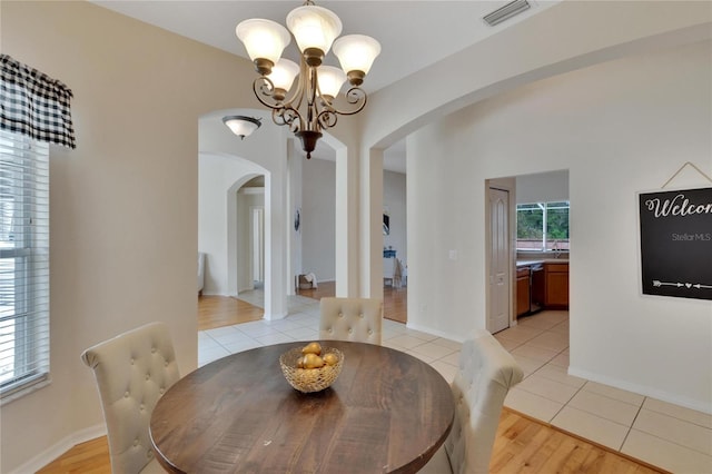 dining room featuring light hardwood / wood-style floors and a notable chandelier