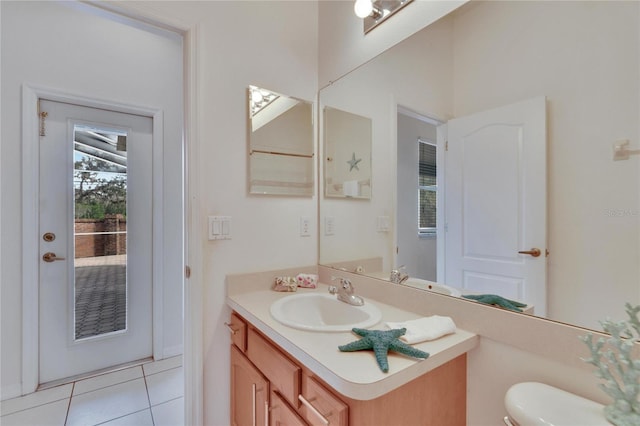 bathroom featuring toilet, vanity, and tile patterned floors