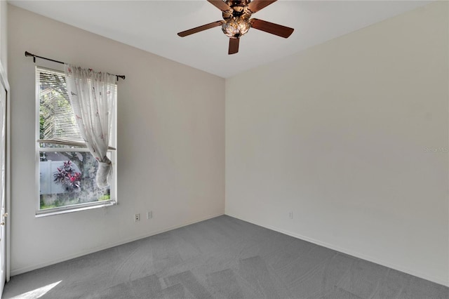 unfurnished room featuring ceiling fan and carpet