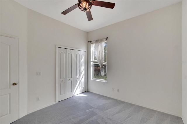 unfurnished bedroom with light carpet, a closet, and ceiling fan