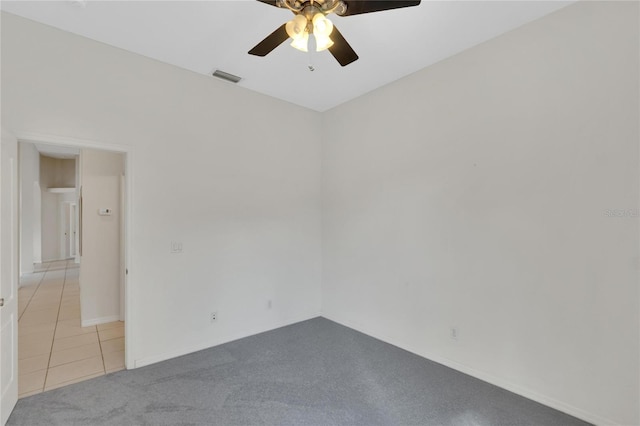 empty room featuring ceiling fan and light tile patterned flooring