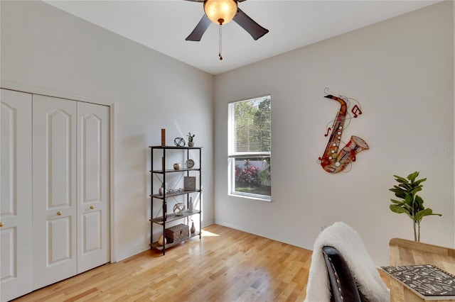 office with light hardwood / wood-style flooring and ceiling fan