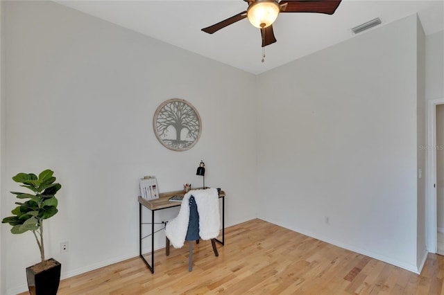 home office with ceiling fan and light hardwood / wood-style flooring