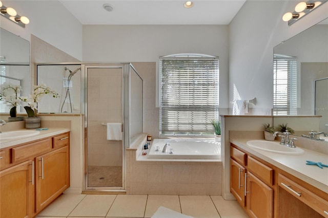 bathroom featuring vanity, tile patterned floors, and separate shower and tub