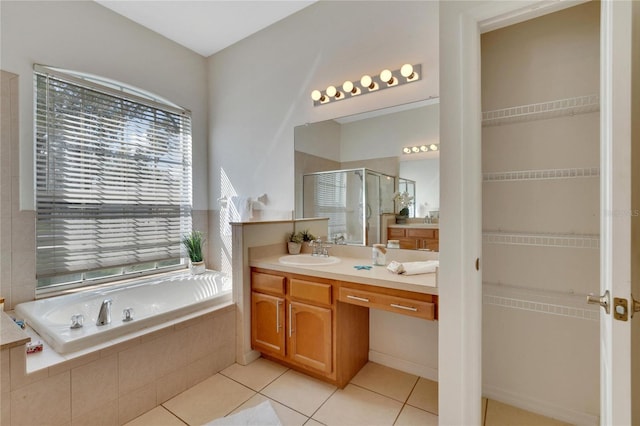 bathroom featuring vanity, plus walk in shower, and tile patterned flooring