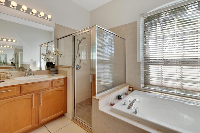 bathroom featuring vanity, tile patterned floors, independent shower and bath, and plenty of natural light