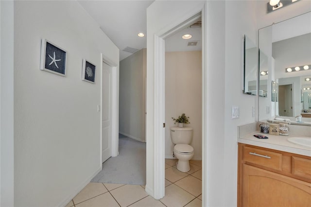 bathroom featuring toilet, vanity, and tile patterned floors