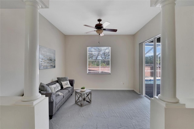 sitting room featuring ceiling fan, decorative columns, and carpet floors