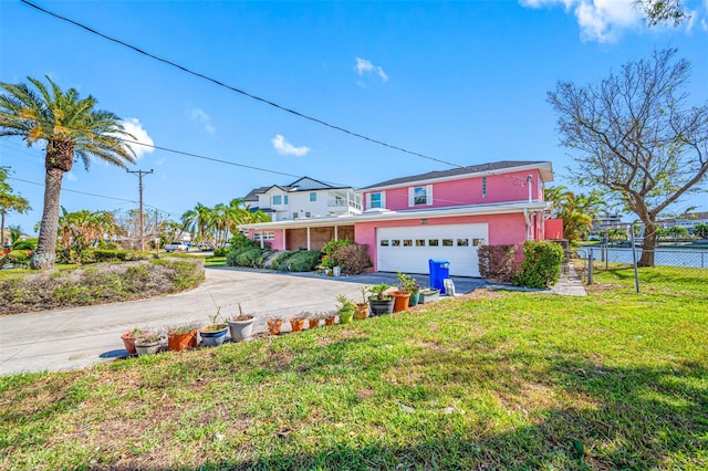 front of property with a garage and a front lawn