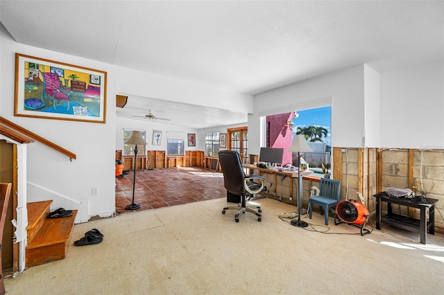 office space with carpet, a textured ceiling, and ceiling fan