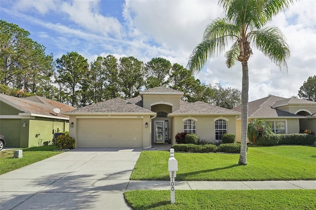 view of front of house with a garage and a front lawn