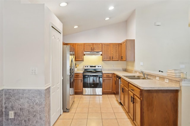 kitchen featuring light tile patterned floors, stainless steel appliances, lofted ceiling, and sink