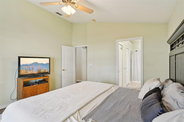 bedroom featuring ensuite bathroom, vaulted ceiling, and ceiling fan