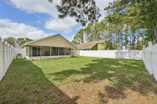 rear view of property with a sunroom and a lawn