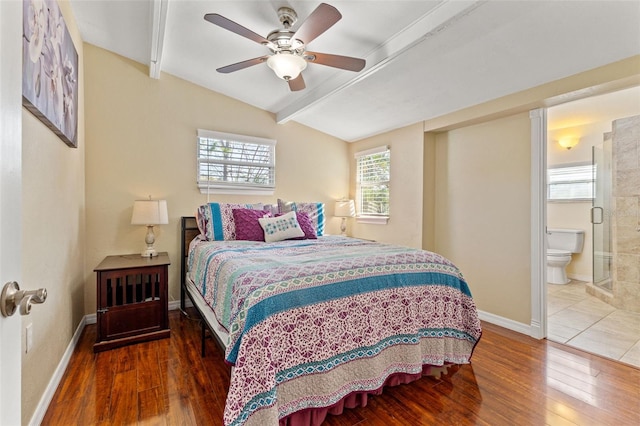 bedroom with vaulted ceiling with beams, ensuite bathroom, ceiling fan, and dark hardwood / wood-style flooring