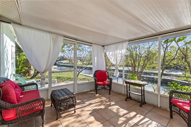 sunroom / solarium with a water view