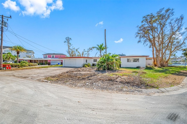 5412 Pali Way, St Pete Beach, FL 33706 - view of front of property featuring concrete driveway and a garage